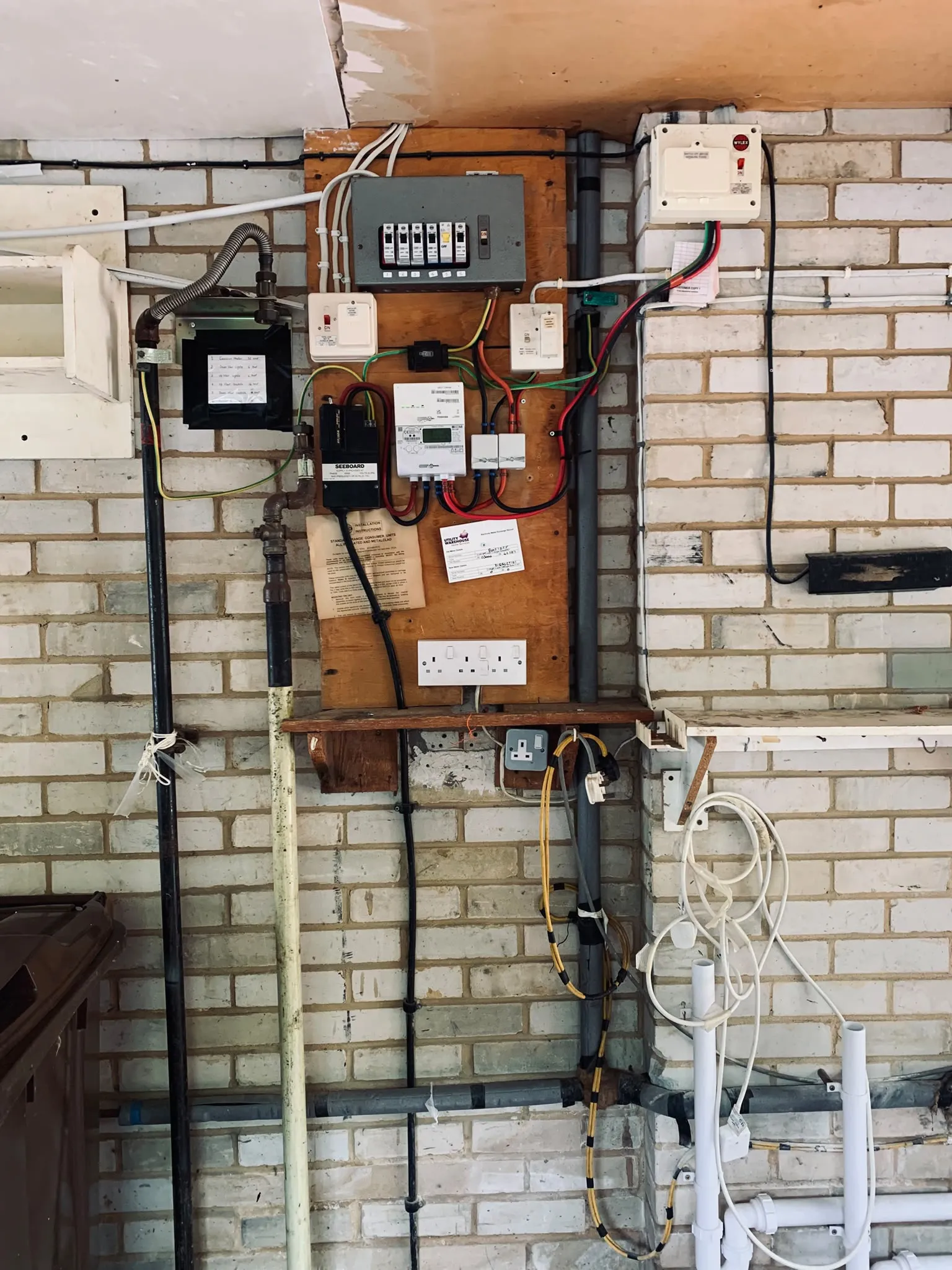 Wider view of the existing consumer unit and electrical installation