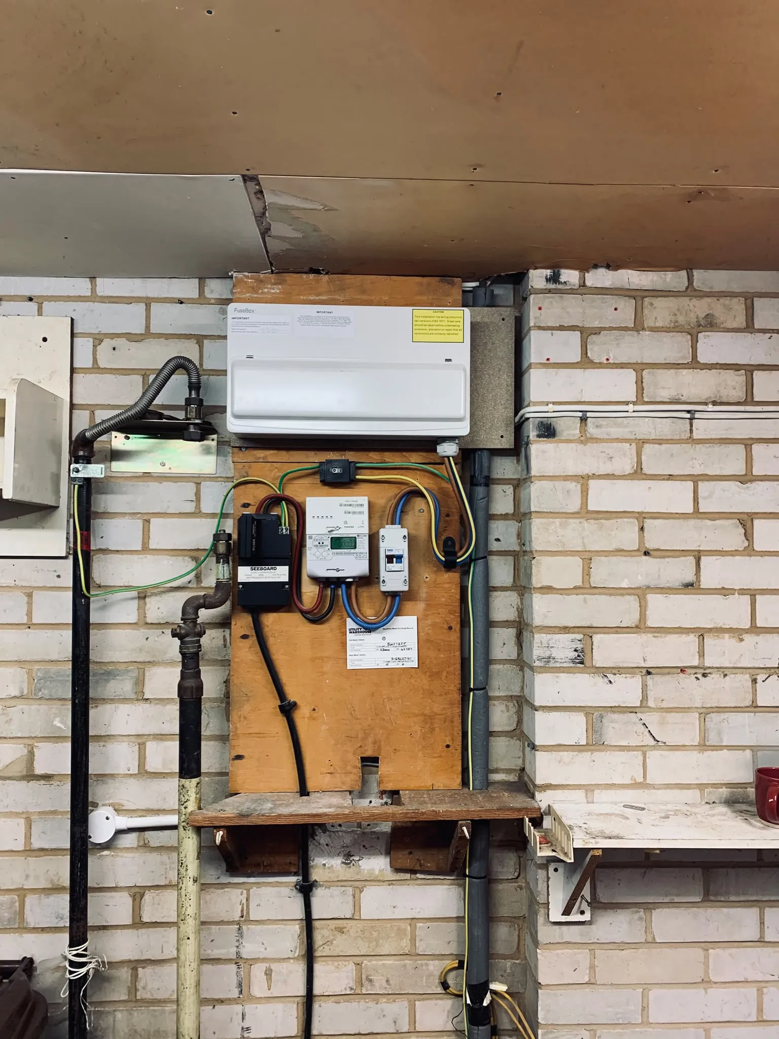Replacement consumer unit mounted above the metering equipment